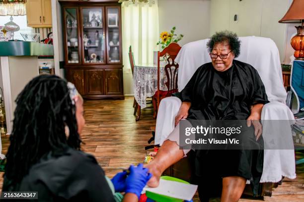 pedicure for elder at home - natural hair curlers stock pictures, royalty-free photos & images