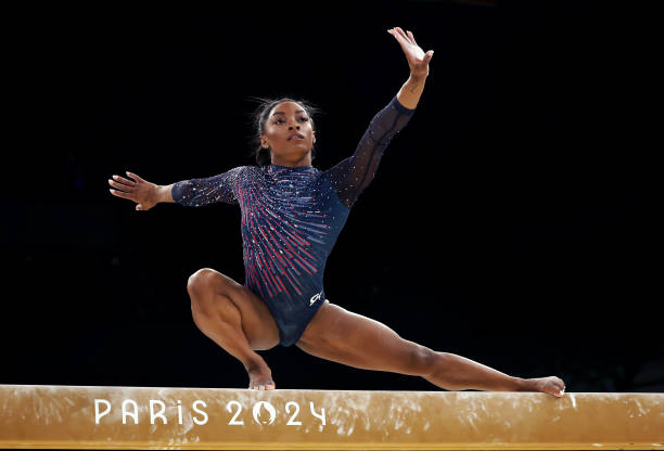Simone Biles of Team United States practices on the balance beam during a Gymnastics training session in the Bercy Arena ahead of the Paris 2024...