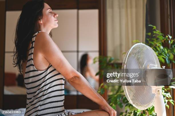 wind from electric fan - person in front of fan stock pictures, royalty-free photos & images