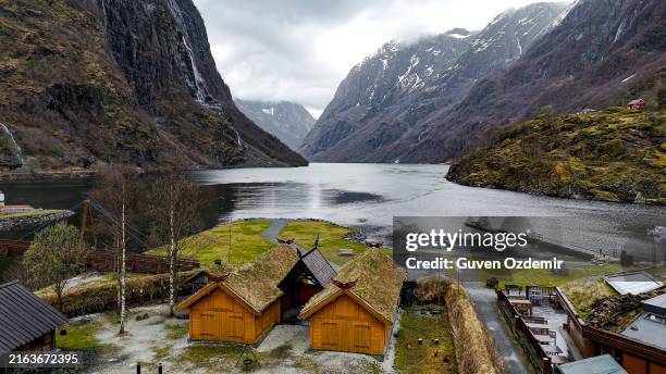 aerial view of njardarheimr viking valley in gudvangen, norway, surrounded by the nærøyfjord and dramatic mountains. - viking ship stock pictures, royalty-free photos & images