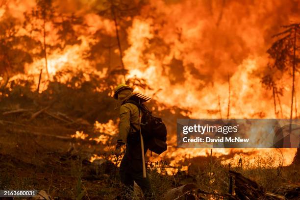 Flames quickly grow as firefighters set a backfire on the eastern front of the Park Fire, which has grown to 360,141 acres and is 12 percent...