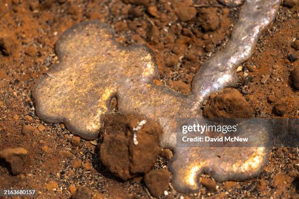 Melted aluminum is seen by a burned truck near the small community of Payne Creek is seen at the Park Fire, which has grown to 360,141 acres and is...