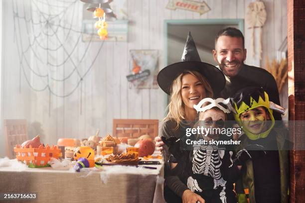 portrait of happy family oh halloween in dining room. - dressing up stock pictures, royalty-free photos & images