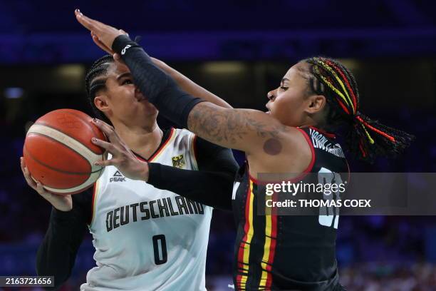Germany's Satou Sabally attempts to go to the basket past Belgium's Maxuella Lisowa Mbaka in the women's preliminary round group C basketball match...