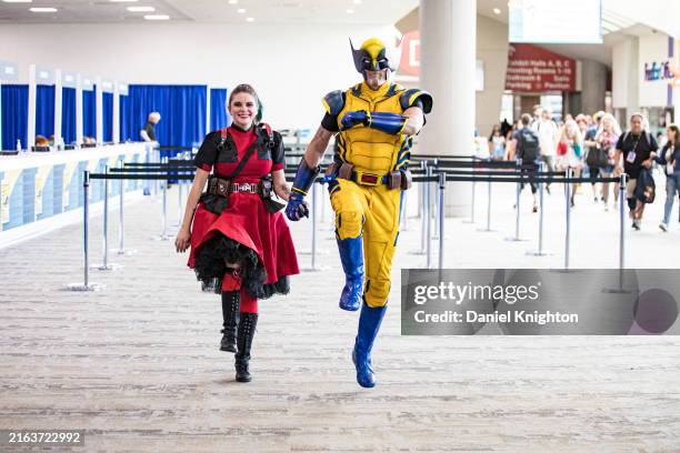 Cosplayers Shawn Richter dressed as Wolverine and Lisa Lower-Richter dressed as Deadpool pose during Day 1 of Comic-Con International on July 25,...