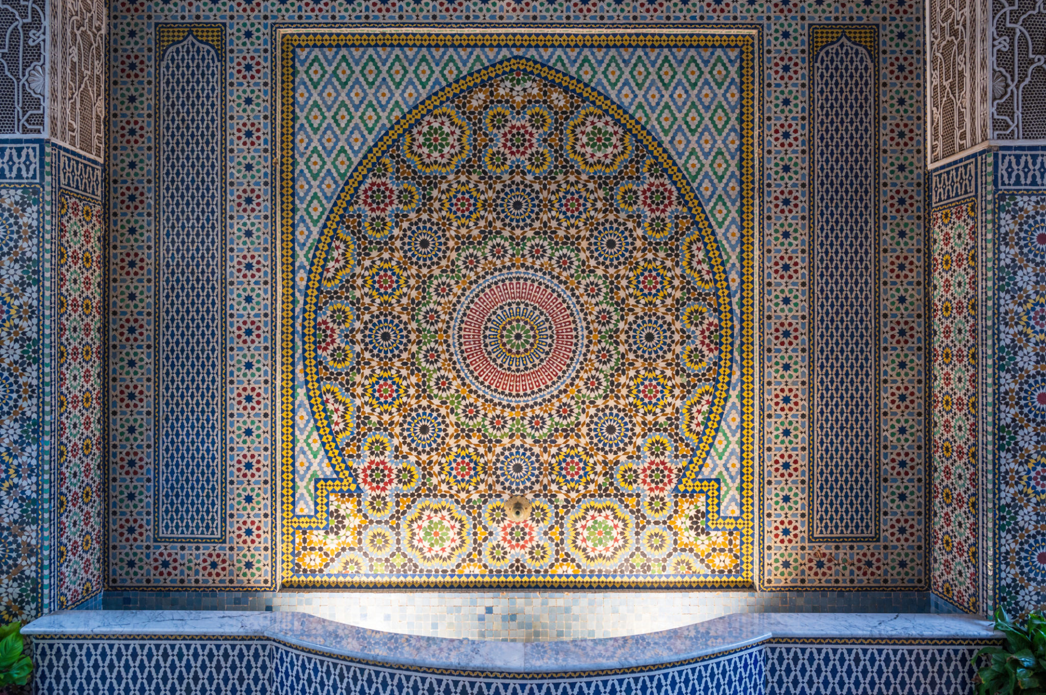Intricate mosaic decoration in Marrakesh, Morroco. Islamic patterns around an ancient water well. Intricate mosaic decoration in Marrakesh, Morroco. Islamic patterns around an ancient water well.