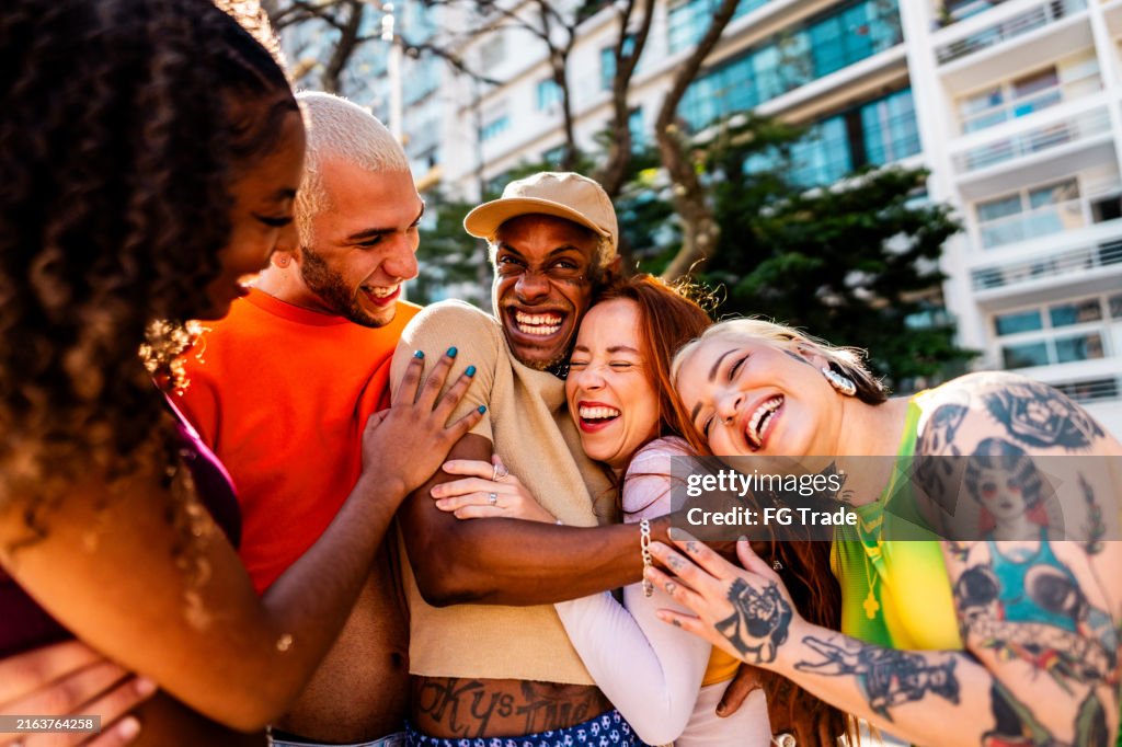 LGBTQIA+ friends embracing and talking outdoors