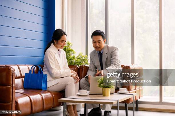 Wealth Adviser Talking To Client In Hotel Louge High-Res Stock Photo