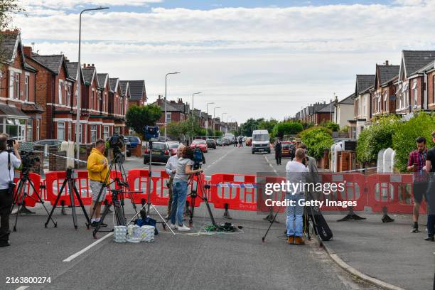 Journalists stand near the scene of a stabbing attack on July 29, 2024 in Southport, England. The North West Ambulance Service says they were...