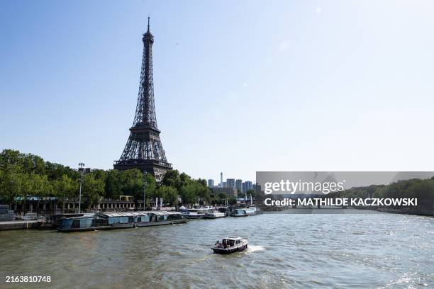 Photograph of the Eiffel Tower with the Olympic rings and the Seine River in Paris, France on July 29, 2024.