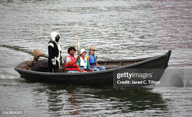 The Olympic Torch is seen at the beginning of the athletes parade on the Seine during the opening ceremony of the Olympic Games Paris 2024 on July...