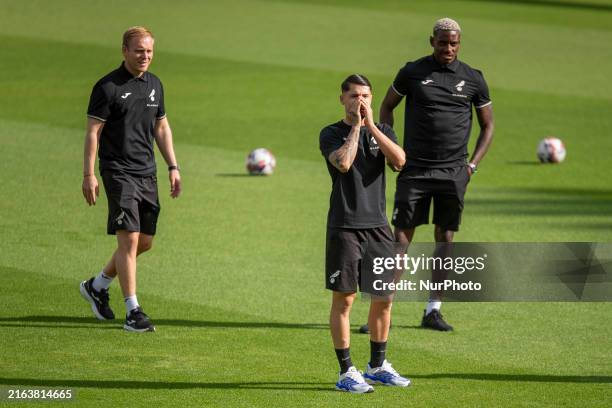 Borja Sainz of Norwich City, Jose Cordoba of Norwich City, and Norwich City Manager, Johannes Hoff Thorup, are interacting with teammates off picture...