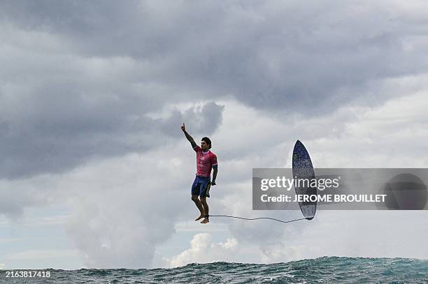 Brazil's Gabriel Medina reacts after getting a large wave in the 5th heat of the men's surfing round 3, during the Paris 2024 Olympic Games, in...