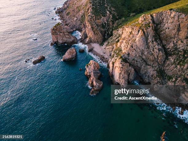 aerial view of sunset over rocky coastline - rocky coastline stock pictures, royalty-free photos & images