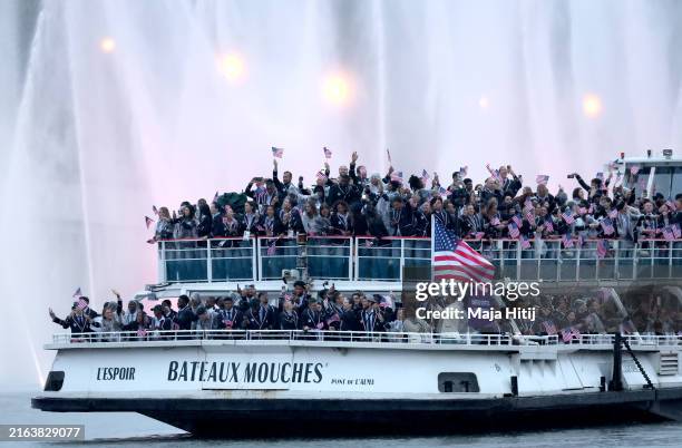 General view as Members of Team United States pass water jets after going through the water curtain under the Austerlitz Bridge on the River Seine...