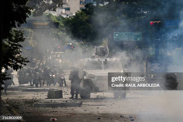 An armoured police car drives through teargas during a protest against Venezuelan President Nicolas Maduro in Caracas on July 29 a day after the...