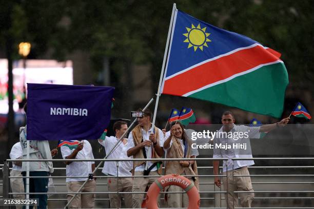 Vera Looser and Alex Miller, Flagbearers of Team Namibia, wave the flag during the athletes’ parade during the opening ceremony of the Olympic Games...