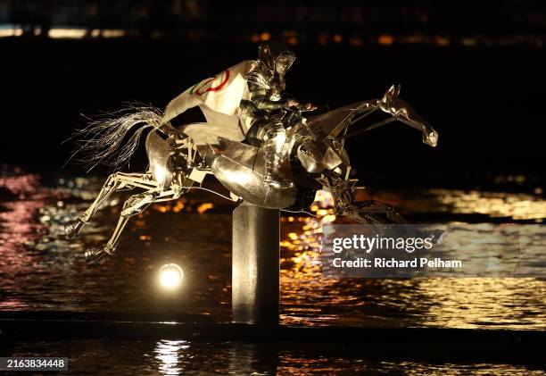 The Horsewoman, wearing the Flag of the International Olympic Committee , is seen on a Metal Horse on the River Seine during the opening ceremony of...
