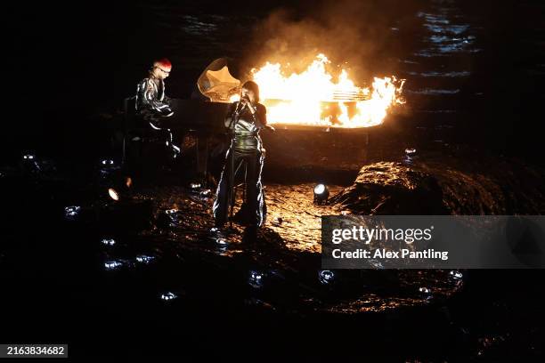 Pianist Sofiane Pamart and French Singer Songwriter Juliette Armanet perform on a Raft on the River Seine during the opening ceremony of the Olympic...