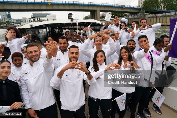 Athletes of the Refugee Olympic Team gesture during the opening ceremony of the Olympic Games Paris 2024 on July 26, 2024 in Paris, France.