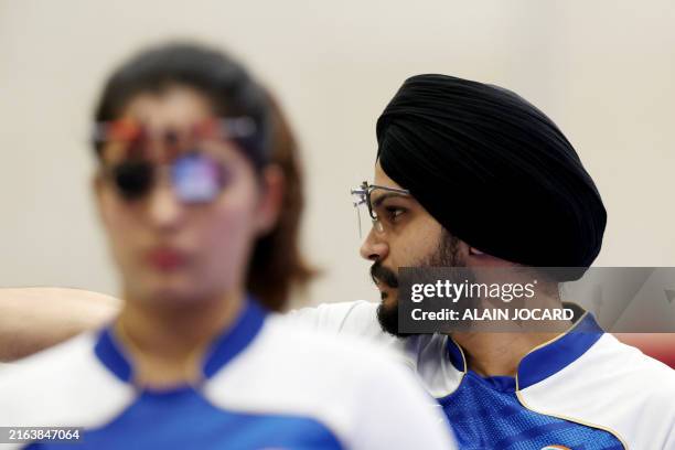 India's Sarabjot Singh competes in the shooting 10m air pistol mixed team bronze medal match during the Paris 2024 Olympic Games at Chateauroux...