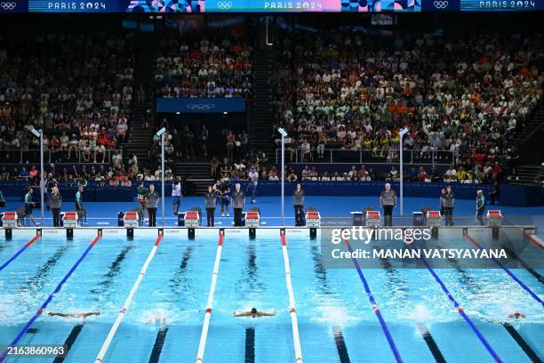 Swimmers take part in a heat of the men's 200m butterfly swimming event during the Paris 2024 Olympic Games at the Paris La Defense Arena in...