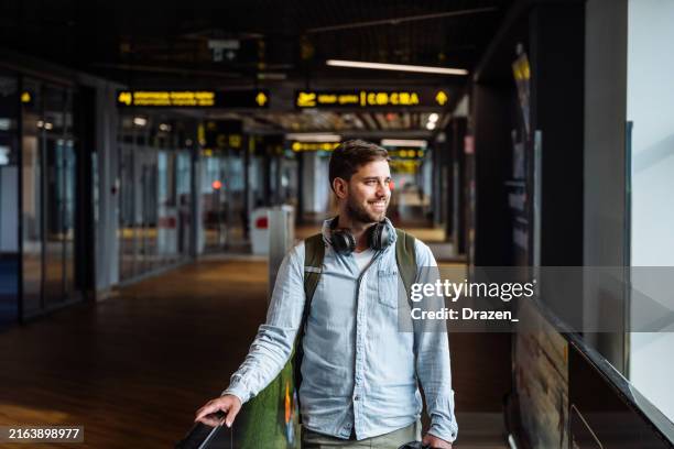 millennial business traveler at the airport - priority boarding stock pictures, royalty-free photos & images