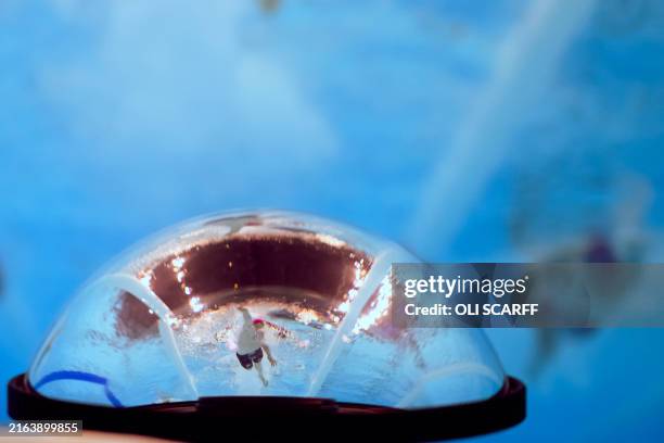 An underwater view shows a reflection in another underwater camera of Britain's Kieran Bird as he competes in a heat of the men's 4x200m freestyle...