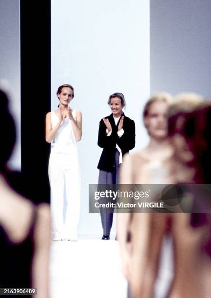 Fashion designer Jil Sander and Amber Valletta walk the runway during the Jil Sander Ready to Wear Spring/Summer 1997 fashion show as part of the...