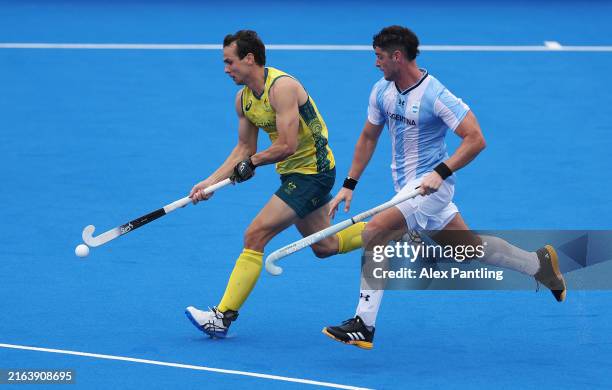 Thomas Craig of Team Australia runs with the ball whilst under pressure from Juan Catan of Team Argentina during the Men's Pool B match between...