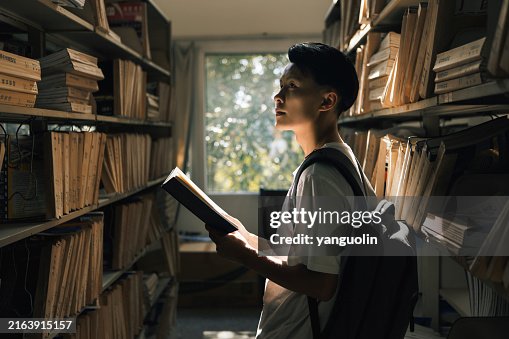 College Students Reading Books in the Library - Youth Culture, Knowledge Themes, Reading and Life College Students Reading Books in the Library - Youth Culture, Knowledge Themes, Reading and Life