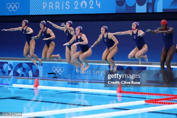 Members of Team United States jump into the pool before the Women's Preliminary Round - Group B match between Team Greece and Team United States on...