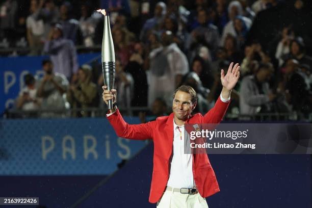 Rafael Nadal of Team Spain holds aloft the Olympic Torch during the opening ceremony of the Olympic Games Paris 2024 on July 26, 2024 in Paris,...