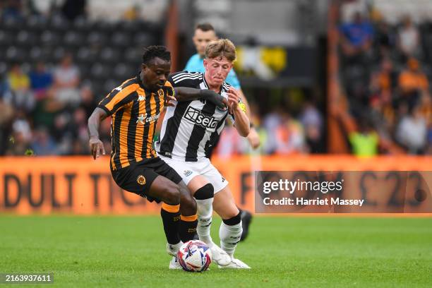 Jay Turner-Cooke of Newcastle United jostles for the ball with Jean Michael Seri of Hull City during the pre-season friendly between Hull City and...
