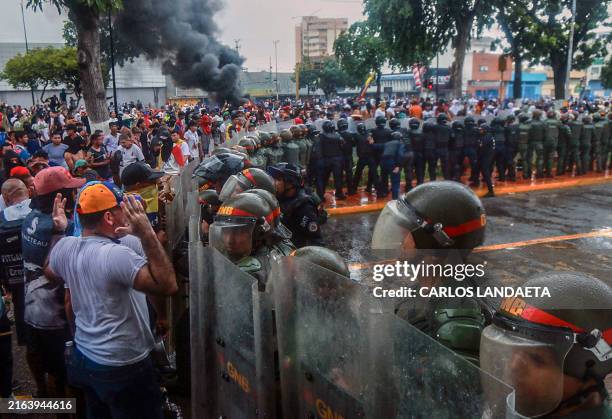 Demonstrators confront riot police during a protest against Venezuelan President Nicolas Maduro's government in Puerto La Cruz, Anzoategui state,...