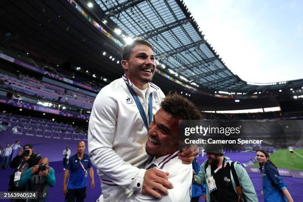 Antoine Dupont of Team France celebrates with teammate Jordan Sepho his gold medal during the Men’s Rugby Sevens medal ceremony on day one of the...