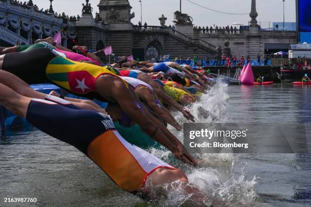Competitors jump into the River Seine in the Men's Individual Triathlon event at the Paris 2024 Olympic Games in Paris, France, on Wednesday, July...