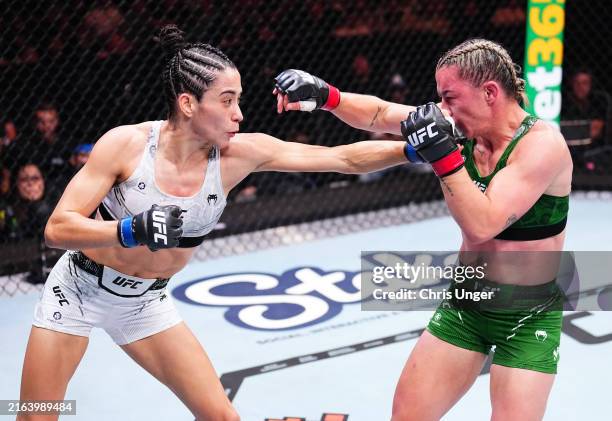 Bruna Brasil of Brazil punches Molly McCann of England in a strawweight bout during the UFC 304 event at Co-op Live on July 27, 2024 in Manchester,...