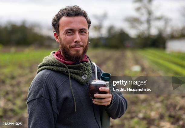 argentinean farmer drinking mate in an agricultural field - gaucho stock pictures, royalty-free photos & images
