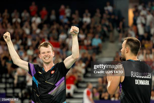 Denmark's Kim Astrup and Anders Skaarup Rasmussen celebrate their win against Japan in the men's doubles badminton group stage match during the Paris...