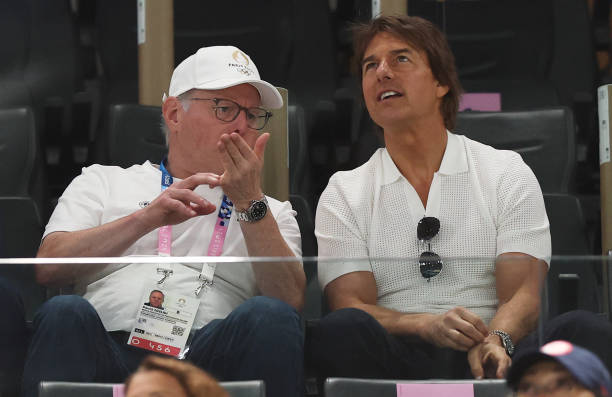 Tom Cruise speaks with David Zaslav as they attend the Artistic Gymnastics Women's Qualification on day two of the Olympic Games Paris 2024 at Bercy...