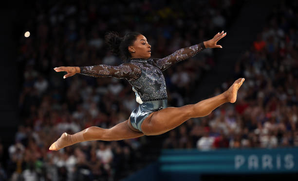 Simone Biles of Team United States competes in the floor exercise during the Artistic Gymnastics Women's Qualification on day two of the Olympic...