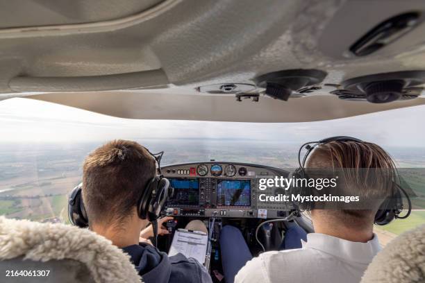 pilots flying light aircraft over countryside - small plane flight stock pictures, royalty-free photos & images