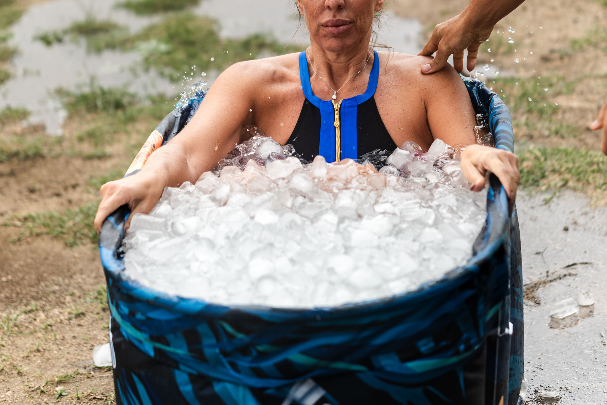 Athlete woman taking ice bath after running workout Athlete woman taking ice bath after running workout
