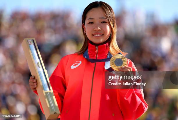 Gold medalist Coco Yoshizawa of Team Japan poses on the podium during the Women's Street Final on day two of the Olympic Games Paris 2024 at Place de...