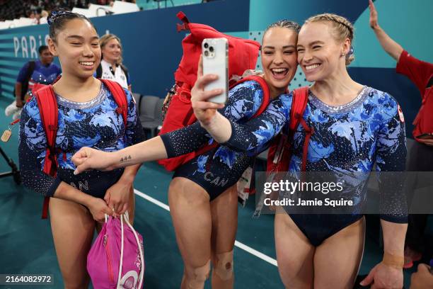 Aurelie Tran, Shallon Olsen and Elsabeth Black, of Team Canada pose for a selfie after the Artistic Gymnastics Women's Qualification on day two of...