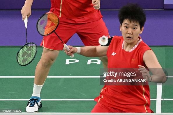 China's Tan Ning plays a shot in the women's doubles badminton... News ...