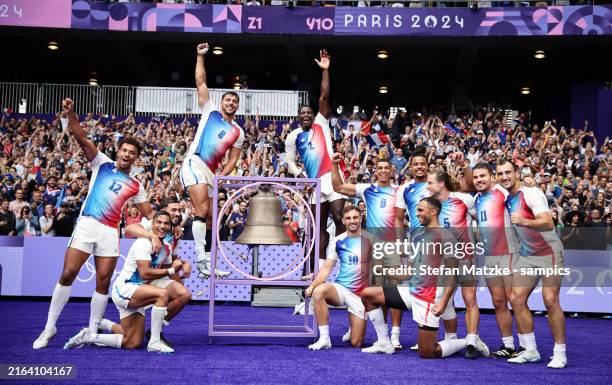 Antoine Zeghdar of Team France and Andy Timo of Team France and the team rings the bell and celebrate with the fans after their sides victory Men’s...