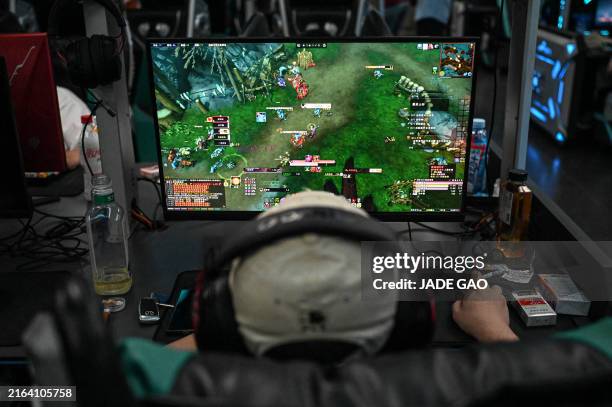 Man plays the online game "World of Warcraft" at an internet cafe in Beijing after US gaming giant Blizzard relaunched its game in China on August 1,...