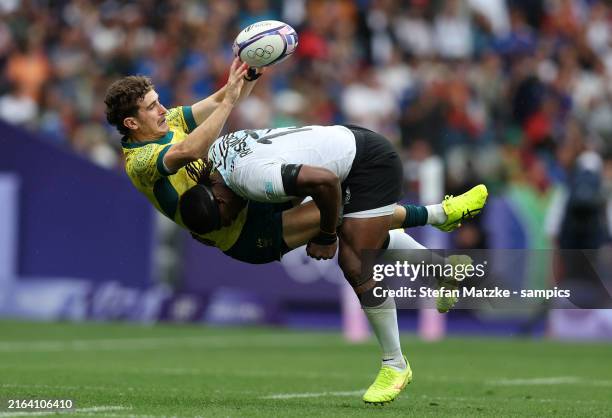 Kaminieli Rasaku of Team Fiji tackles Ben Dowling of Team Australia during Men’s Rugby Sevens Men's Semi-final match between Fiji and Australia on...